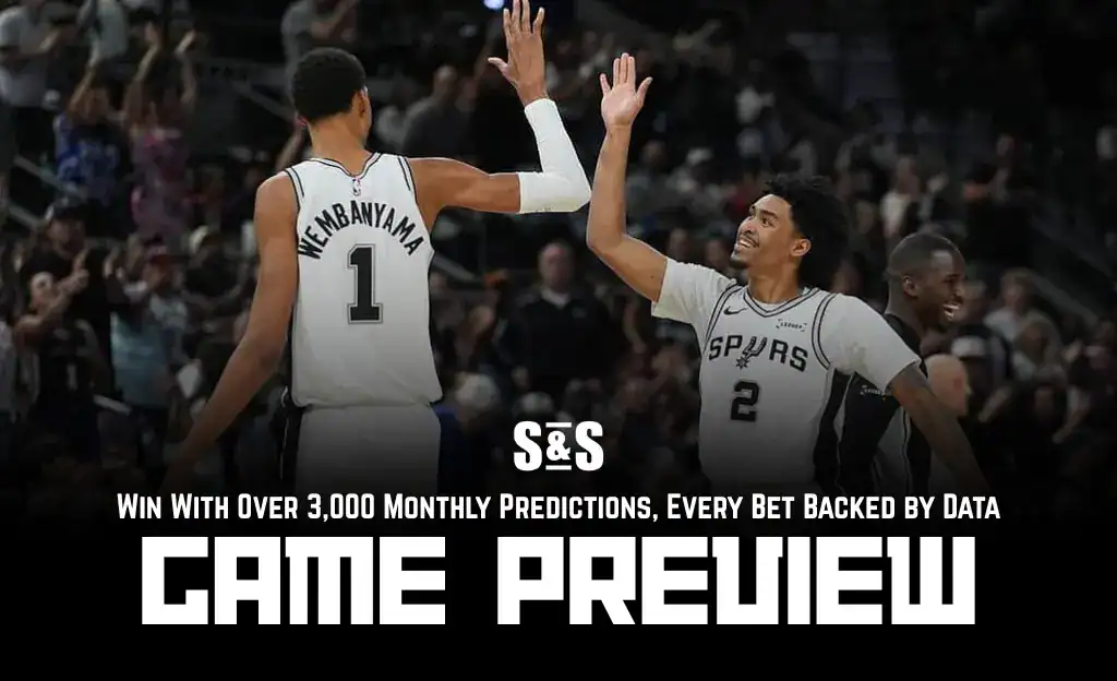 Previews 6 Two basketball players celebrate a play during a game, wearing San Antonio Spurs uniforms, with a crowd cheering in the background.
