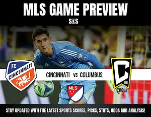A goalkeeper in a blue uniform prepares to make a save, with team logos for FC Cincinnati and Columbus Crew prominently displayed.
