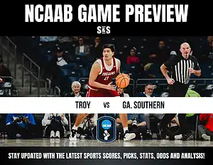 NCAAB game preview image showing a Troy University player dribbling a basketball on a court, with a referee running. Text reads "Troy vs Ga. Southern."