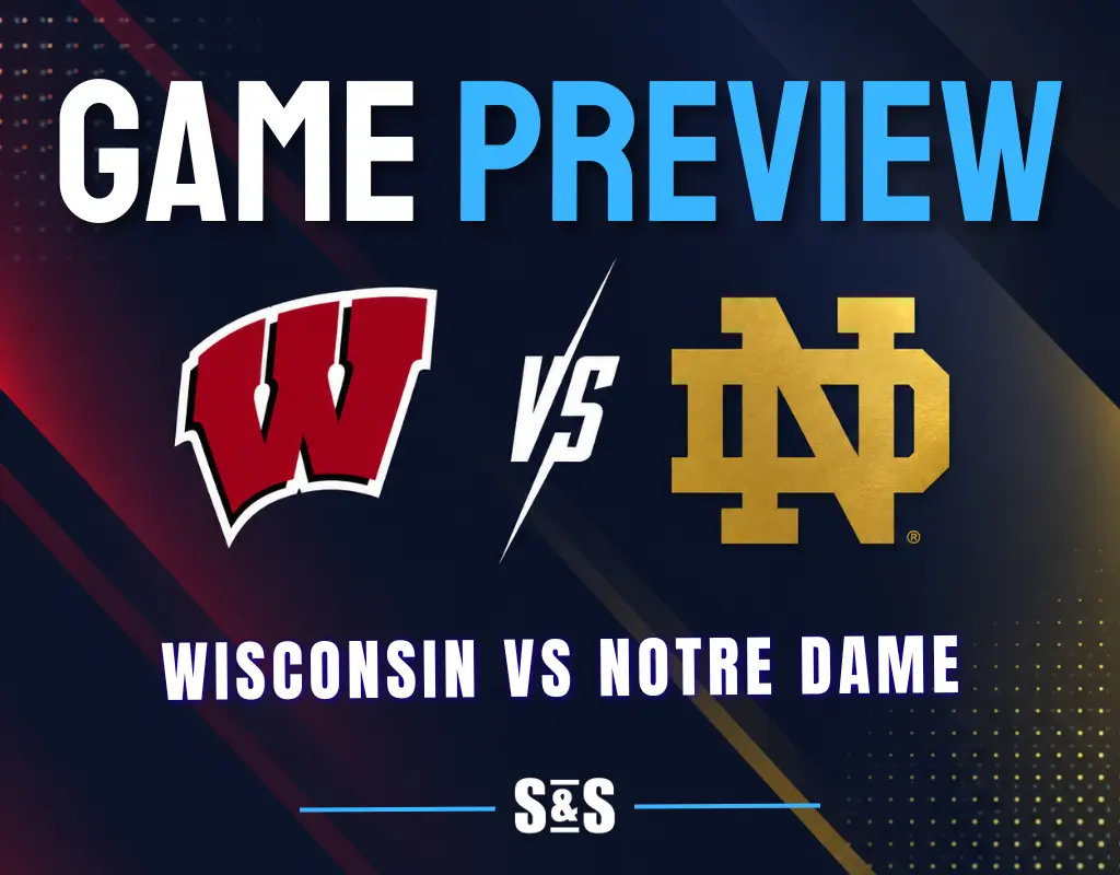 Wisconsin vs Notre Dame: Wisconsin Badgers and Notre Dame Fighting Irish logos separated by a white VS on a dark navy background with red and gold accents.